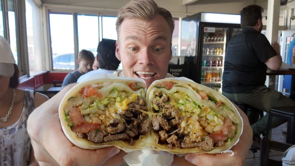 La Peria's Oaxacalifornia burrito is a twist on the traditional California burrito,{ }by adding Oaxaca cheese to its other ingredients, including{ }carne asada, cheese, and French fries inside a flour tortilla.{ }{ }