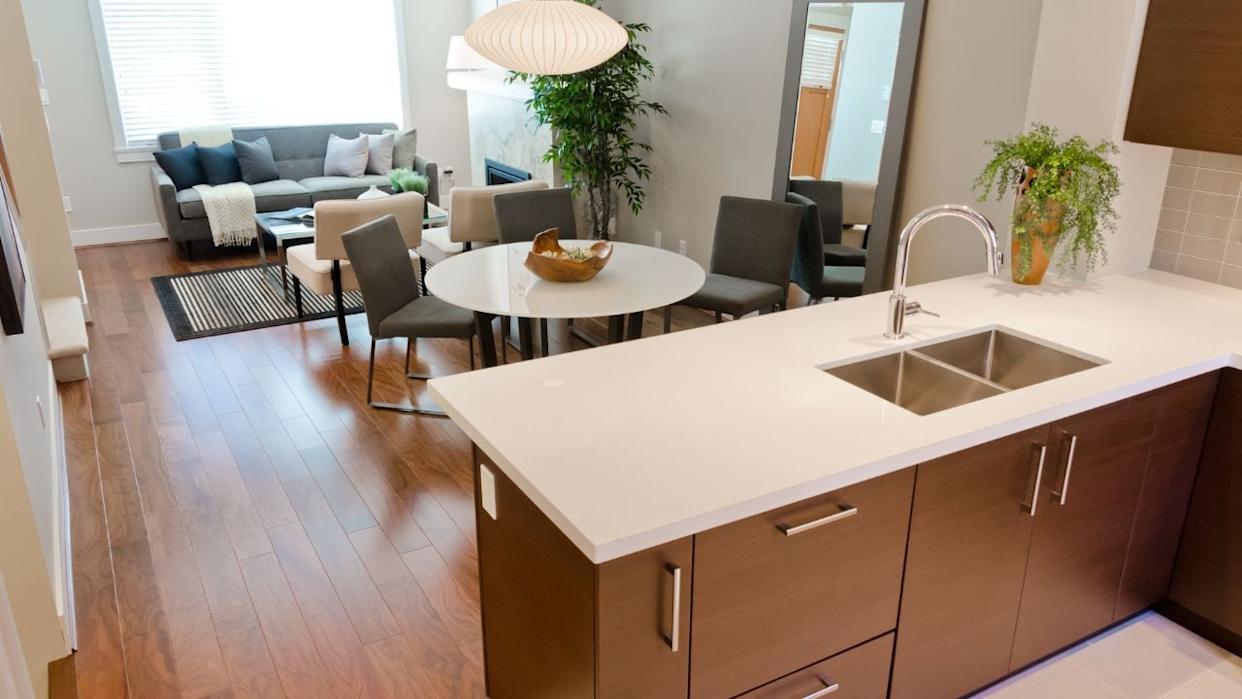 A modern hotel suite with a full kitchen and living area, perfect for families staying near Disneyland