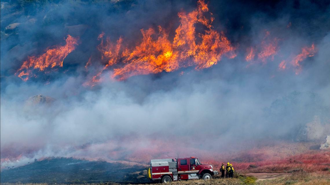 Crews work to contain southern California wildfire as mandatory evacuations remain