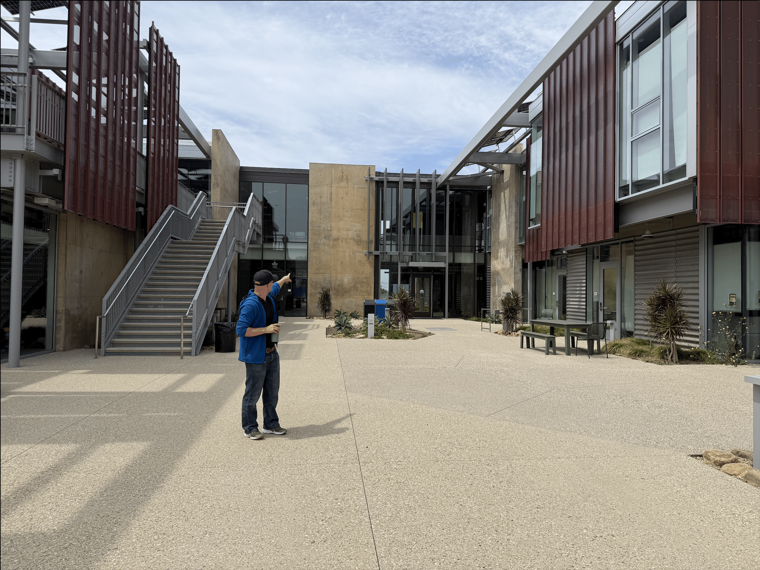 Drew Shula points to the glass windows on Malibu High School's new campus.