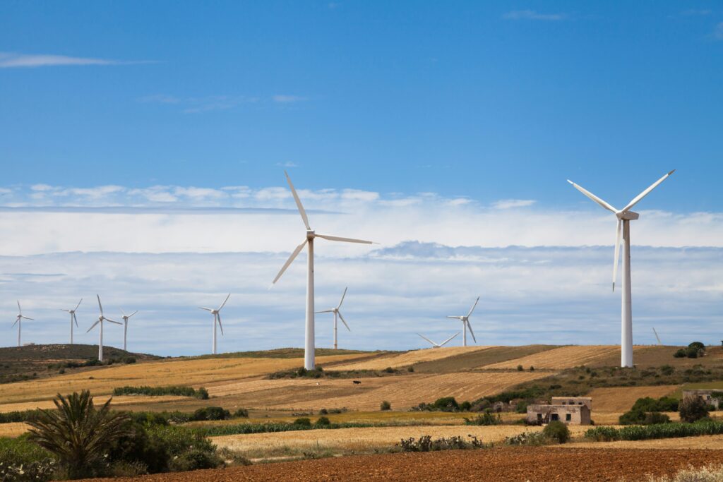 A field of windmills over a grassland