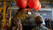 Guests observe the Orion crew module in the welldeck of the amphibious transport dock USS John P. Murtha (LPD 26) after supporting NASA’s Artemis II recovery, Apr. 11, 2026. USS John P. Murtha supported NASA’s Artemis II mission in the U.S. 3rd Fleet area of operations supporting, retrieving the crew and spacecraft following their return to Earth and splashdown in the Pacific Ocean. NASA’s Artemis II mission sent four astronauts on a flight around the moon in the Orion space capsule, marking the first