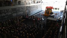 Vice Adm. John Wade, commander, U.S. Third Fleet, receives an appreciation plaque aboard the amphibious transport dock ship USS John P. Murtha (LPD 26) commemorating the Artemis II lunar mission on April 11, 2026. John P. Murtha was underway in the U.S. 3rd Fleet area of operations supporting NASA’s Artemis II mission, retrieving the crew and space craft following their return to Earth and splashdown in the Pacific Ocean. NASA’s Artemis II mission sent four astronauts on a flight around the moon in the Orion space craft, marking the first time humans journeyed to deep space in over 50 years.