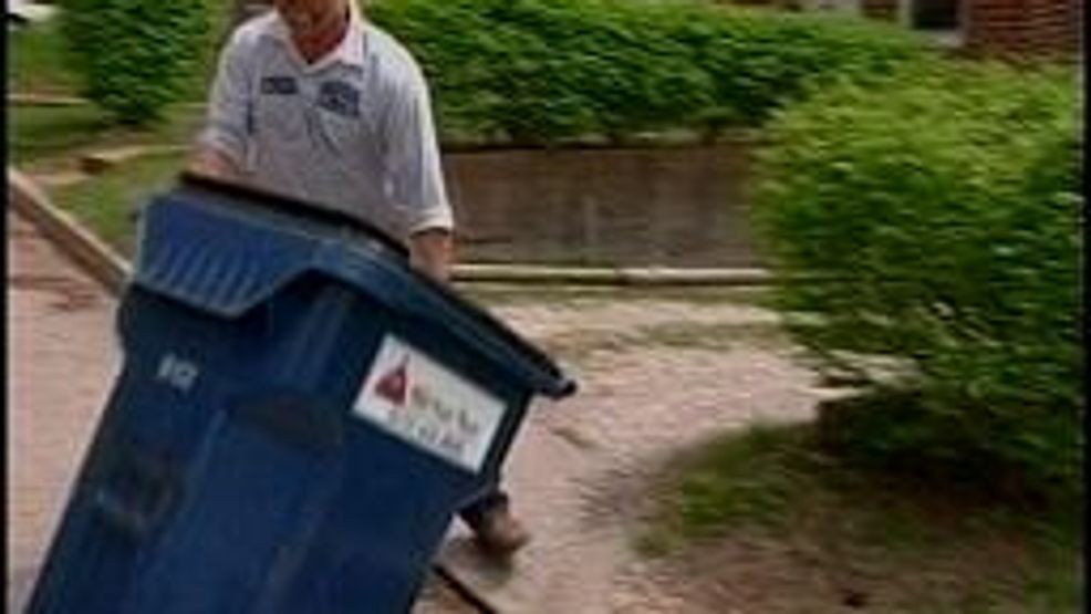 The new program does away with the old trash bag system and requires everyone to use one of the large blue bins.  FILE