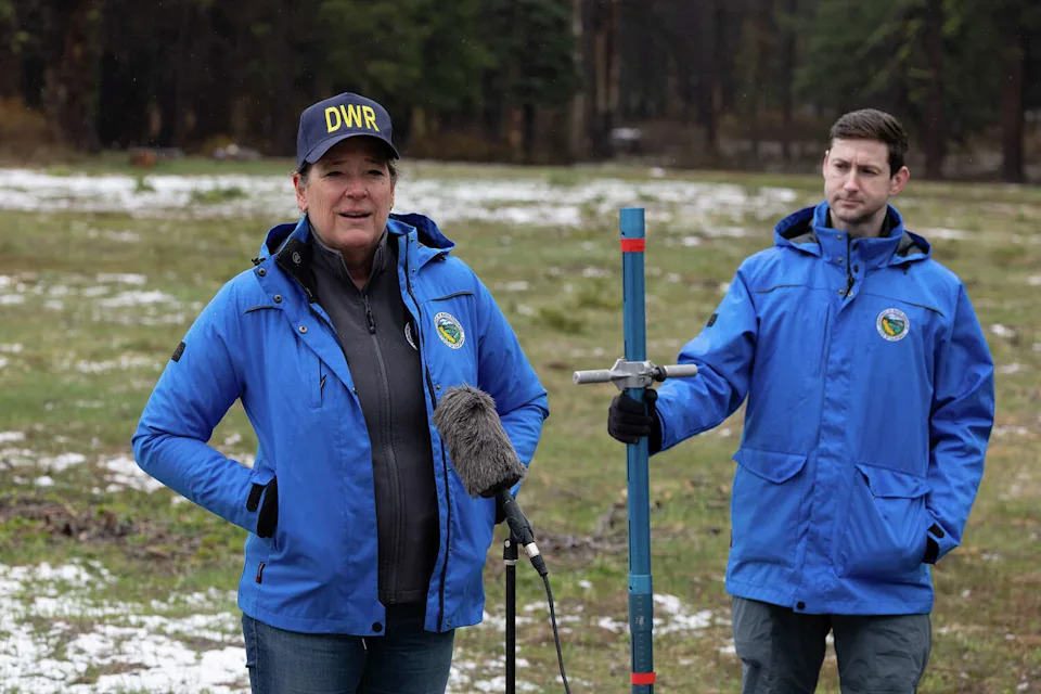 Karla Nemeth, the director of California Department of Water Resources, addresses news media alongside spokesperson Jason Ince at the snow survey on April 1. (Andrew Nixon/California Department of Water Resources)