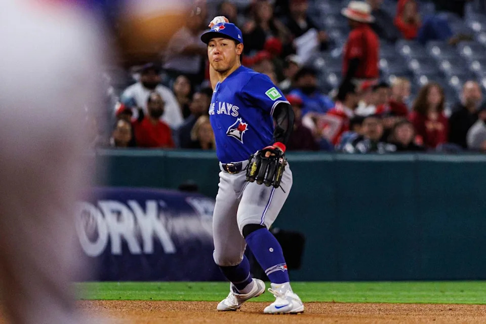 Kazuma Okamoto #7 of the Toronto Blue Jays prepares to throw the ball to first base during an MLB game against the Los Angeles Angels at Angel Stadium on April 21, 2026 in Anaheim, California.