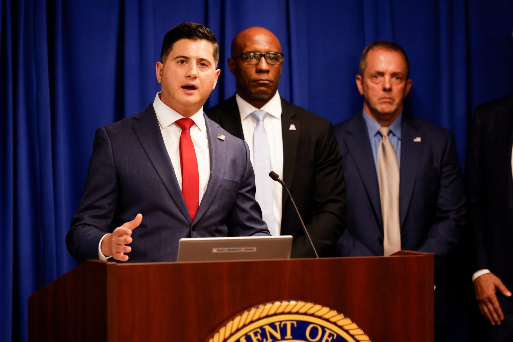 Bill Essayli speaks at a press conference on the fraud epidemic in California.