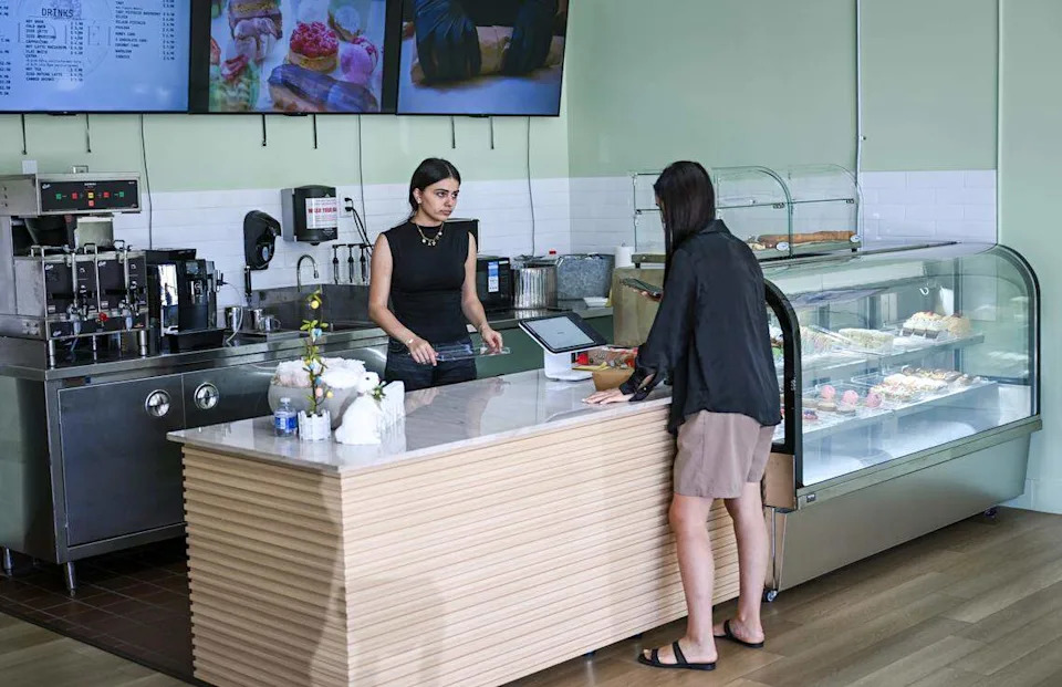 Arpi Keymetlyan helps a customer at Lodéi Bakery & Cafe, an Armenian family-owned bakery on the northeast corner of Palm and Bullard avenues.