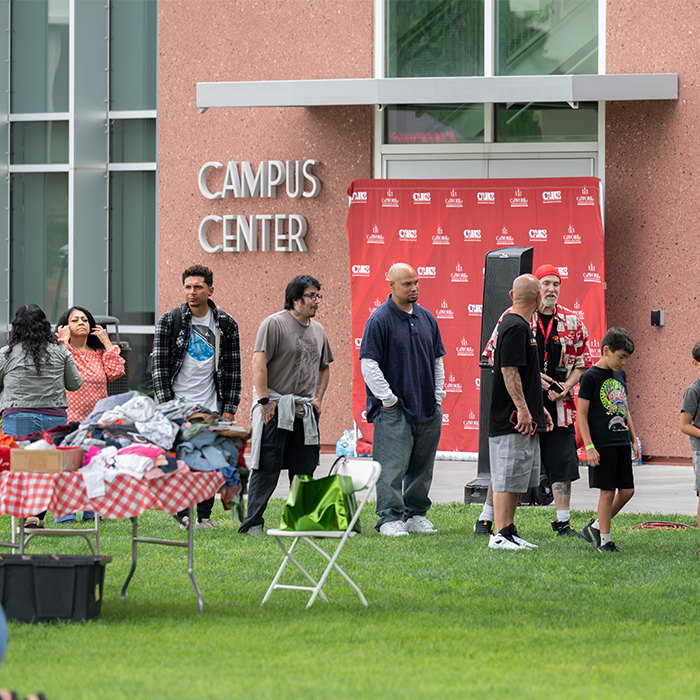 several people standing in line waiting for food