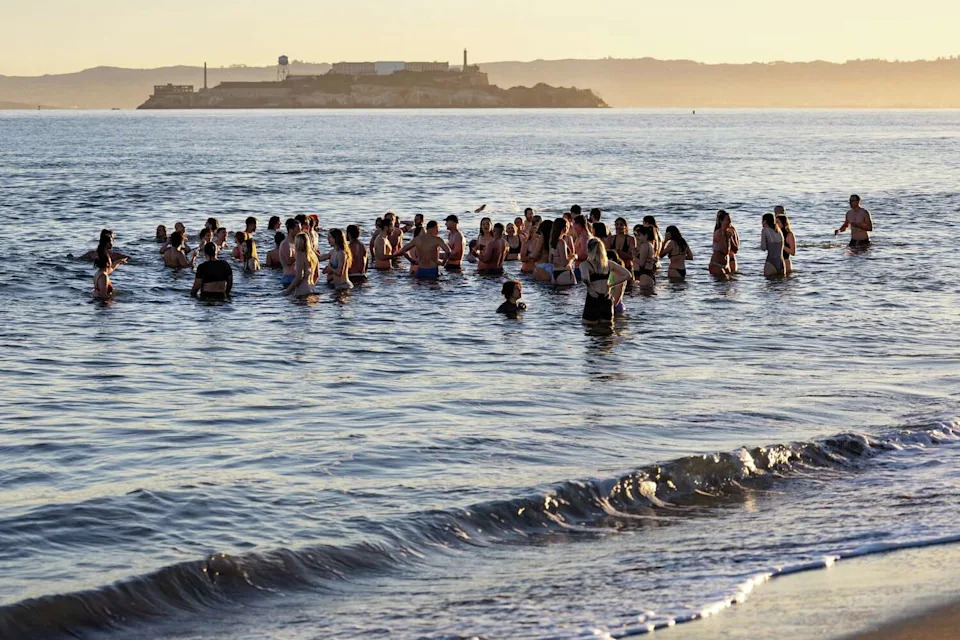 Members of the Salty Dogs Club SF gather in the water during their Friday morning plunge at Crissy Field East Beach in San Francisco, Calif., on Friday, April 3, 2026. (Jana Ašenbrennerová/For the S.F. Chronicle)