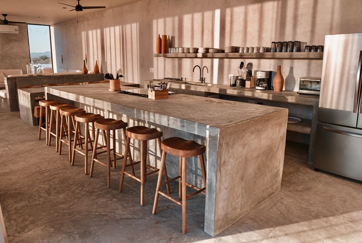 Image may contain Indoors Interior Design Kitchen Kitchen Island Bar Stool Furniture and Plant