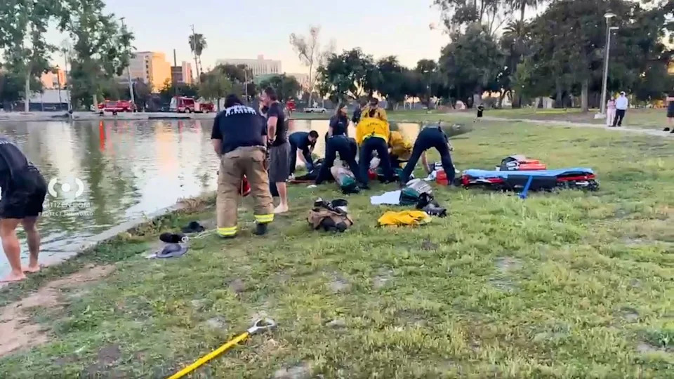 Firefighters and paramedics respond to a reported drowning at Lincoln Park in Lincoln Heights as rescue crews search the water and treat patients on shore.