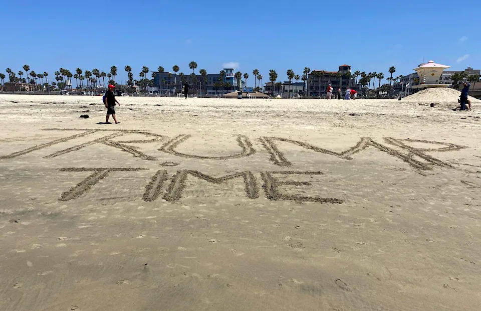 Someone wrote "Trump Time" on the sand at Huntington City Beach
