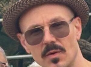 man in hat speaking