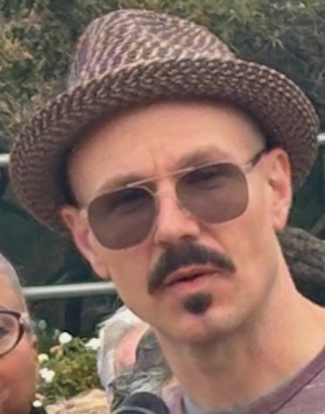 man in hat speaking