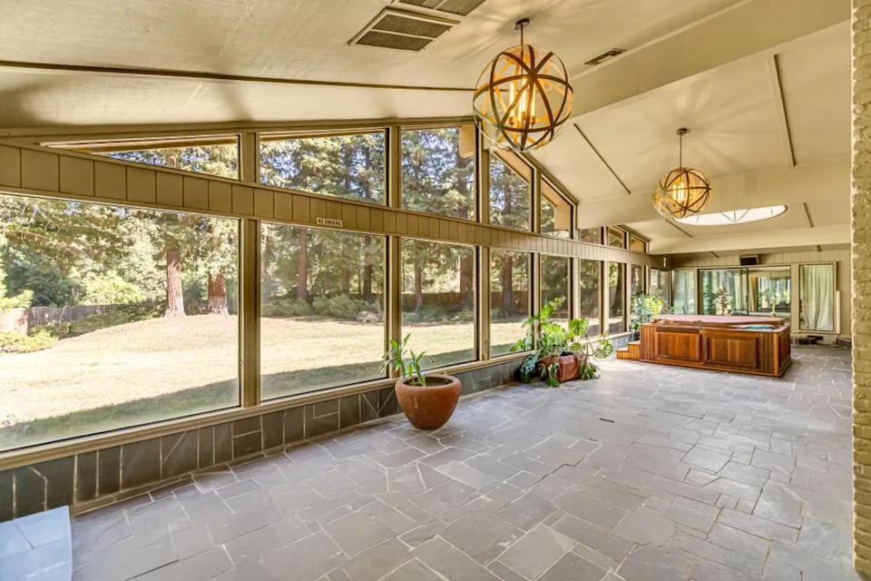 Clerestory windows and a dramatic dome skylight transform the Hazel Avenue home’s sunroom into a light-filled sanctuary that connects indoor and outdoor spaces.