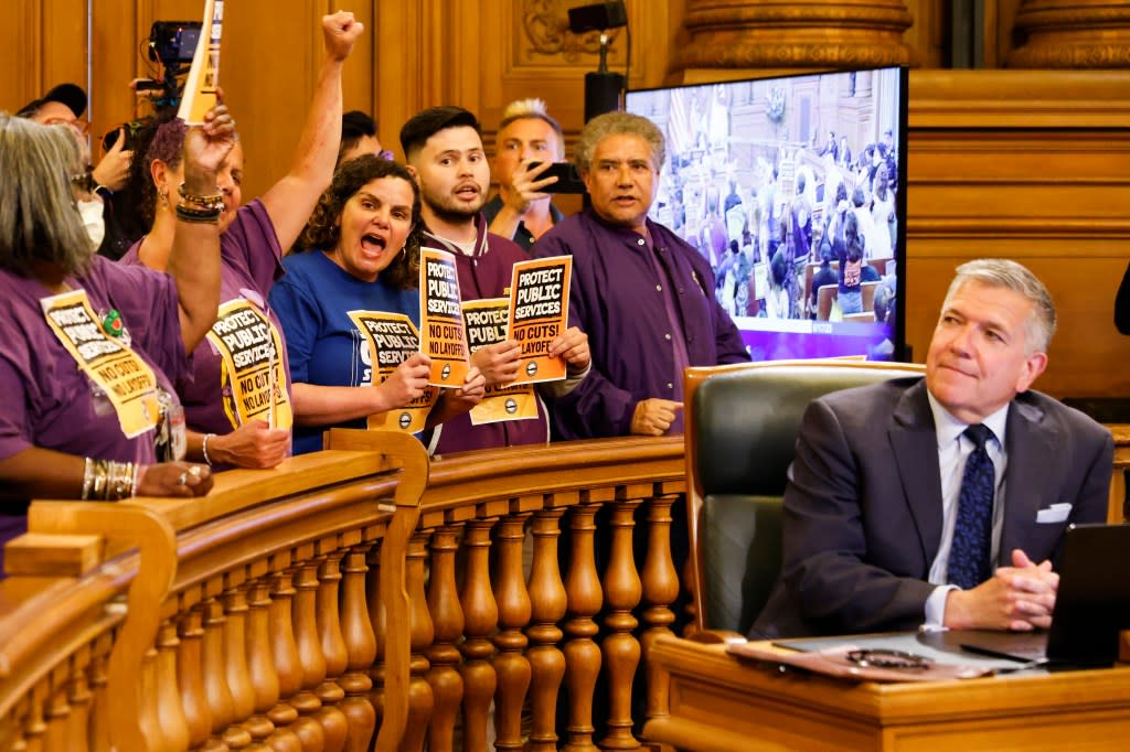 Supervisor Matt Dorsey watches as frontline city workers from IFPTE Local 21, SEIU Local 1021, and the San Francisco Building Trades hold a protest during the weekly San Francisco Supervisors meeting in 2025. San Francisco Chronicle via Getty Images