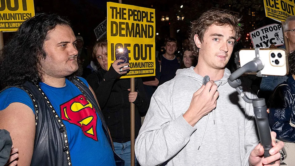 Nick Shirley filming protesters demonstrating against ICE arrests on a city street in New York