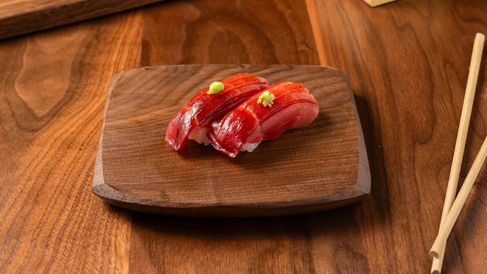 Bluefin chutoro nigiri on a slab of wood at Uchi