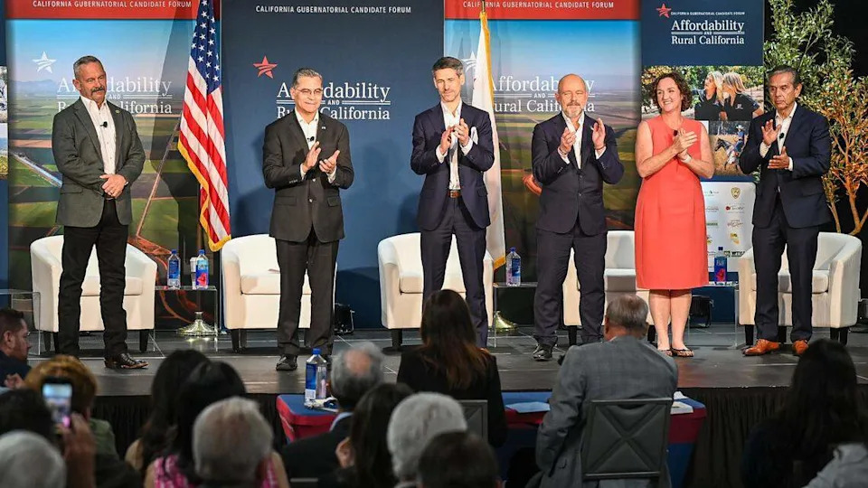 California gubernatorial candidates, from left, Chad Bianco, Xavier Becerra, Matt Mahan, Steve Hilton, Katie Porter, and Antonio Villaraigosa stand on stage at the conclusion of a forum hosted by the Western Growers Association at Fresno State on Wednesday, April 1, 2026.