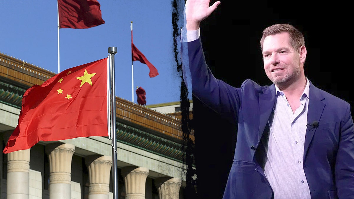 Rep. Eric Swalwell standing near Chinese flags atop a building