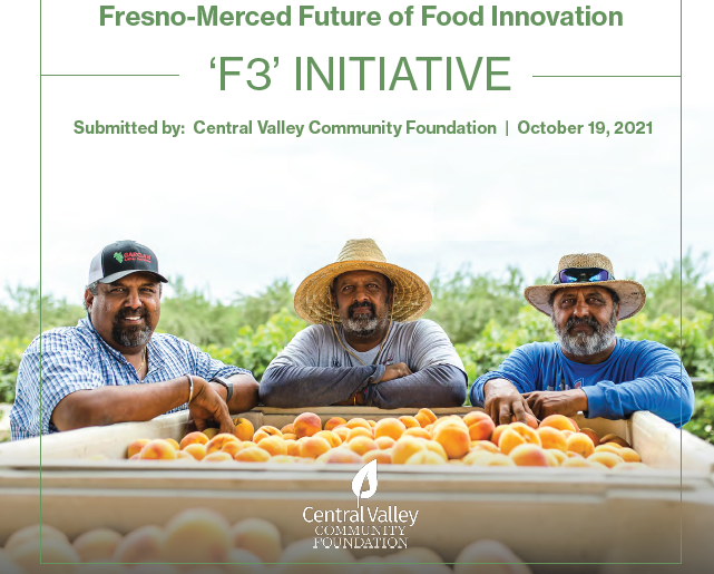 three men standing at a fruit bin