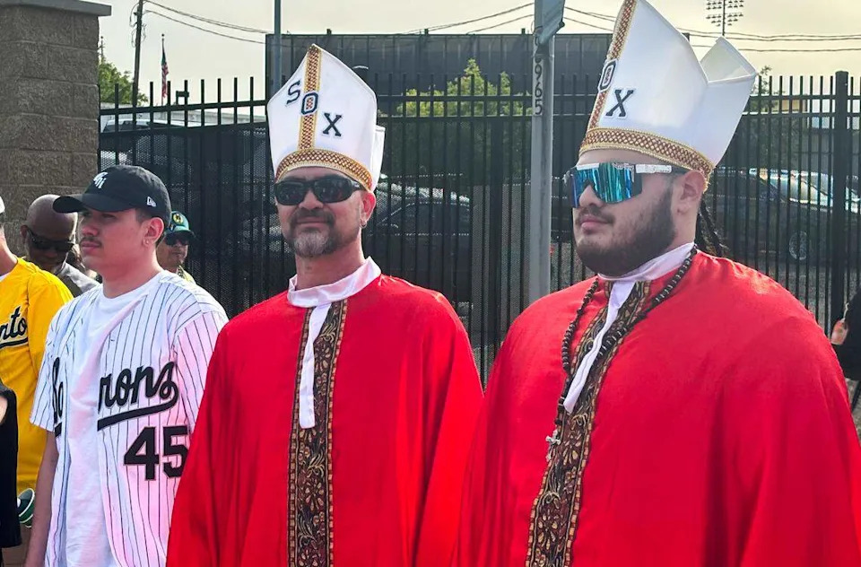 Oscar and Tristan Perez dress in papal garb – a reference to suburban Chicago native Pope Leo XIV – as they attend an Athletics game against the Chicago White Sox in West Sacramento on Saturday.