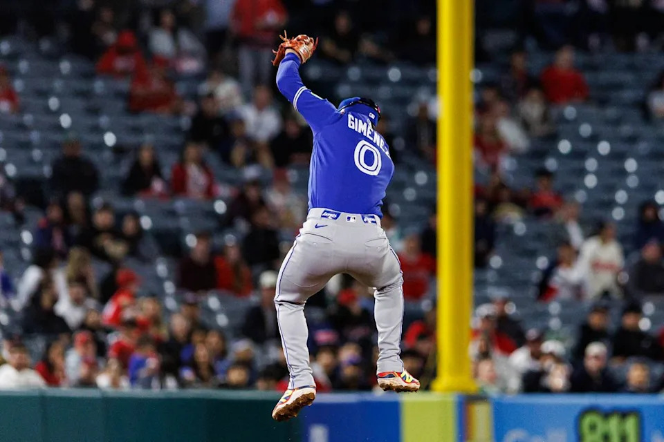 Andrés Giménez #0 of the Toronto Blue Jays jumps to make a catch during an MLB game against the Los Angeles Angels at Angel Stadium on April 21, 2026 in Anaheim, California.