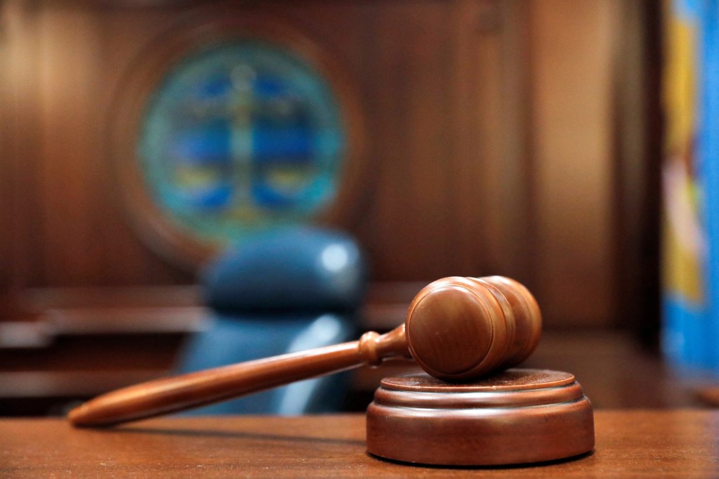 Illustration of a gavel and sound block on a judge's bench.