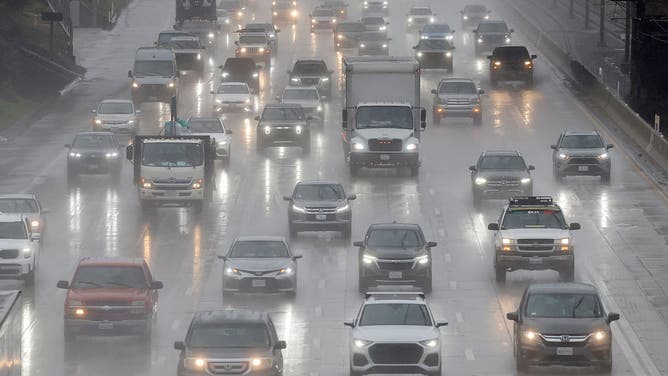 PASADENA, CALIFORNIA - FEBRUARY 16: Motorists drive through rainfall as a storm delivers heavy rain to the region on February 16, 2026 in Pasadena, California.