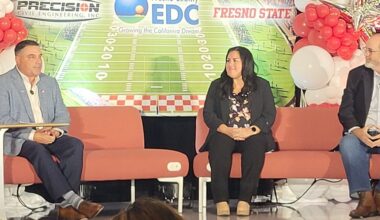 three people on a stage