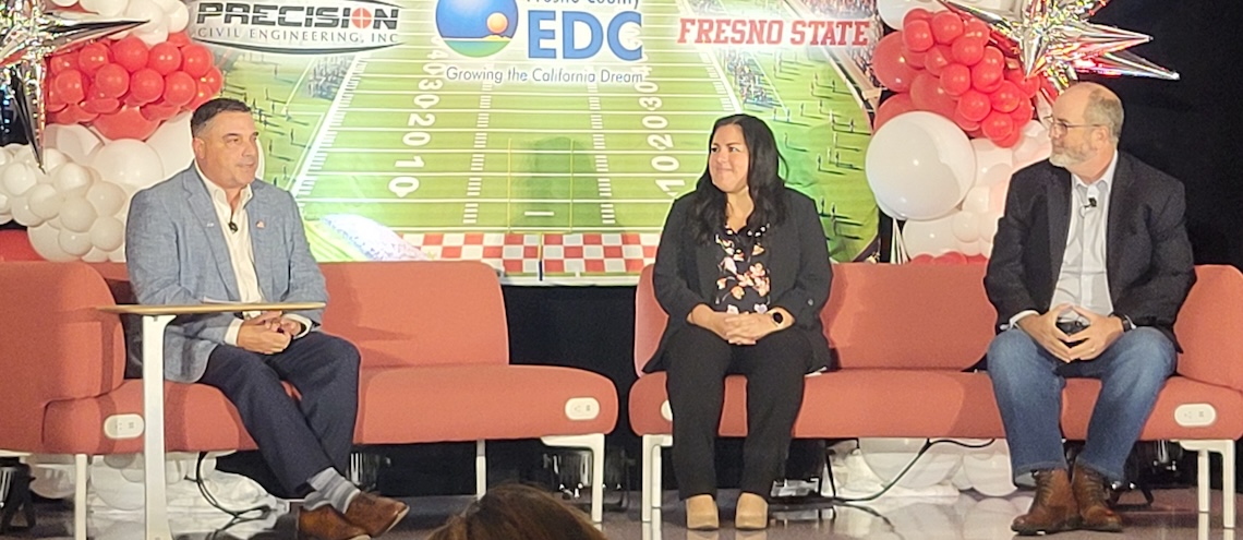 three people on a stage