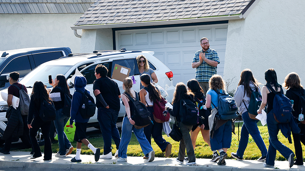 onlookers applaud student walkout protesting ICE