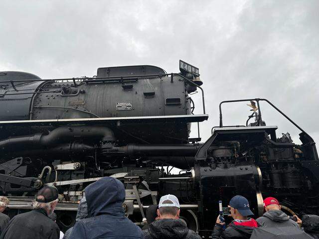 Visitors stand beside Union Pacific Railroad’s Big Boy No. 4014 along Atlantic Street in Roseville’s historic district on Friday, April 10, 2026. The historic steam locomotive traveled through Sutter and Placer counties before arriving in Roseville as part of its multistate 2026 tour.
