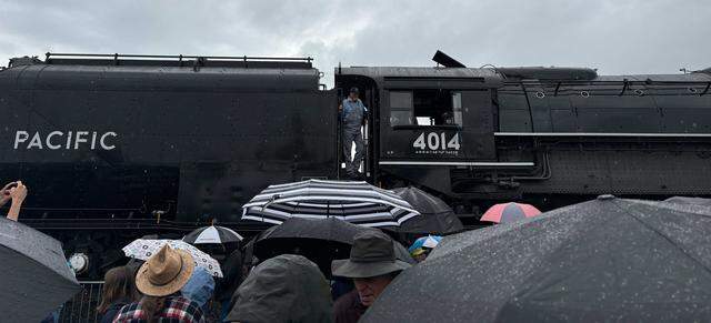 Union Pacific Railroad’s Big Boy No. 4014 is stopped along Atlantic Street in Roseville’s historic district on Friday, April 10, 2026, as visitors gather in the rain to see the locomotive. The steam engine’s visit is part of a coast-to-coast tour celebrating America’s 250th anniversary.