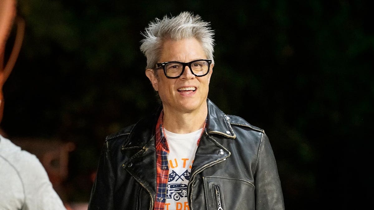 Johnny Knoxville wears glasses and coat