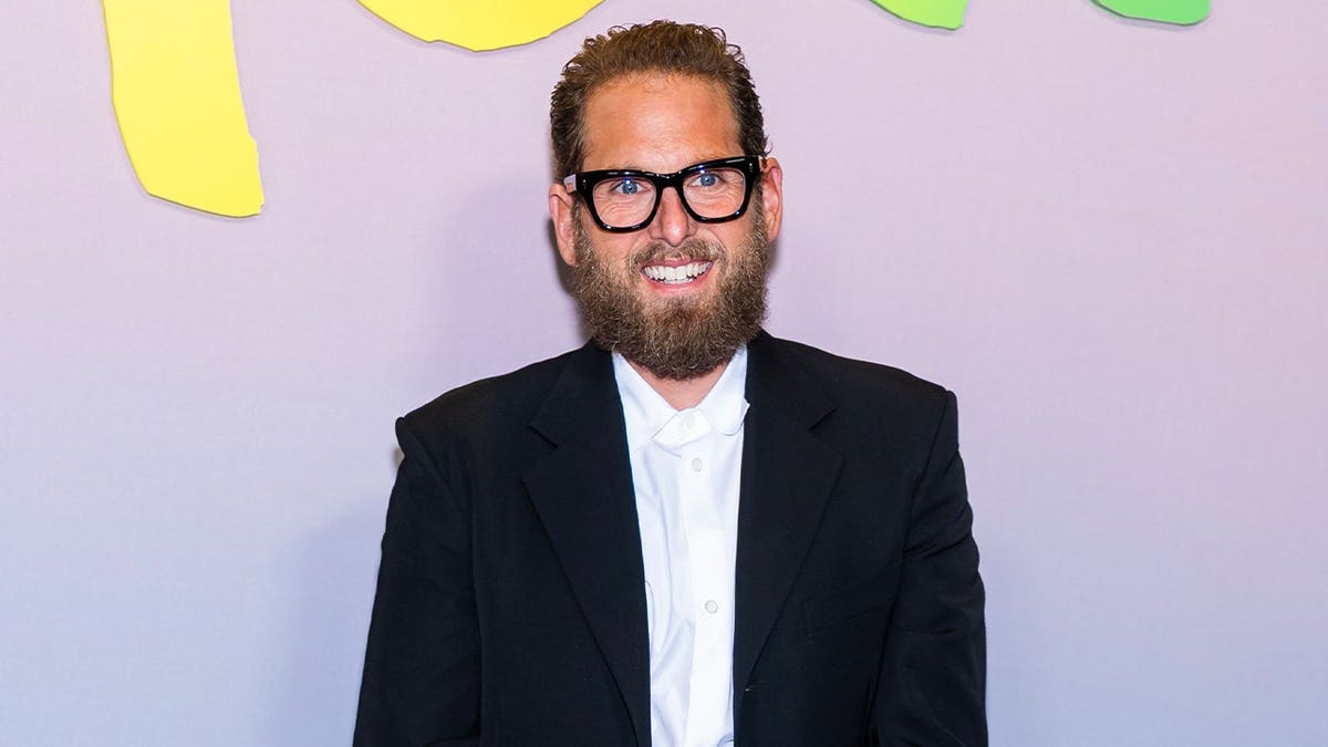 Jonah Hill walks red carpet wearing a suit