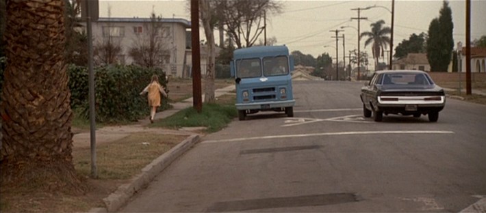 A little girl running towards an ice cream truck