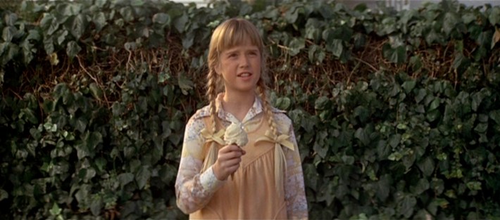 a little girl with an ice cream cone