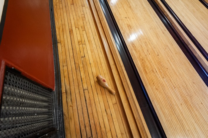 a bowling pin in the middle of a bowling alley