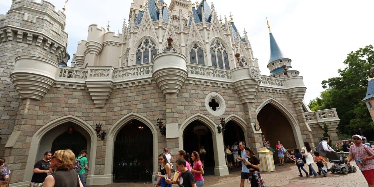 Visitors walk in front of Cinderella Castle at Magic Kingdom on the Fantasyland side.