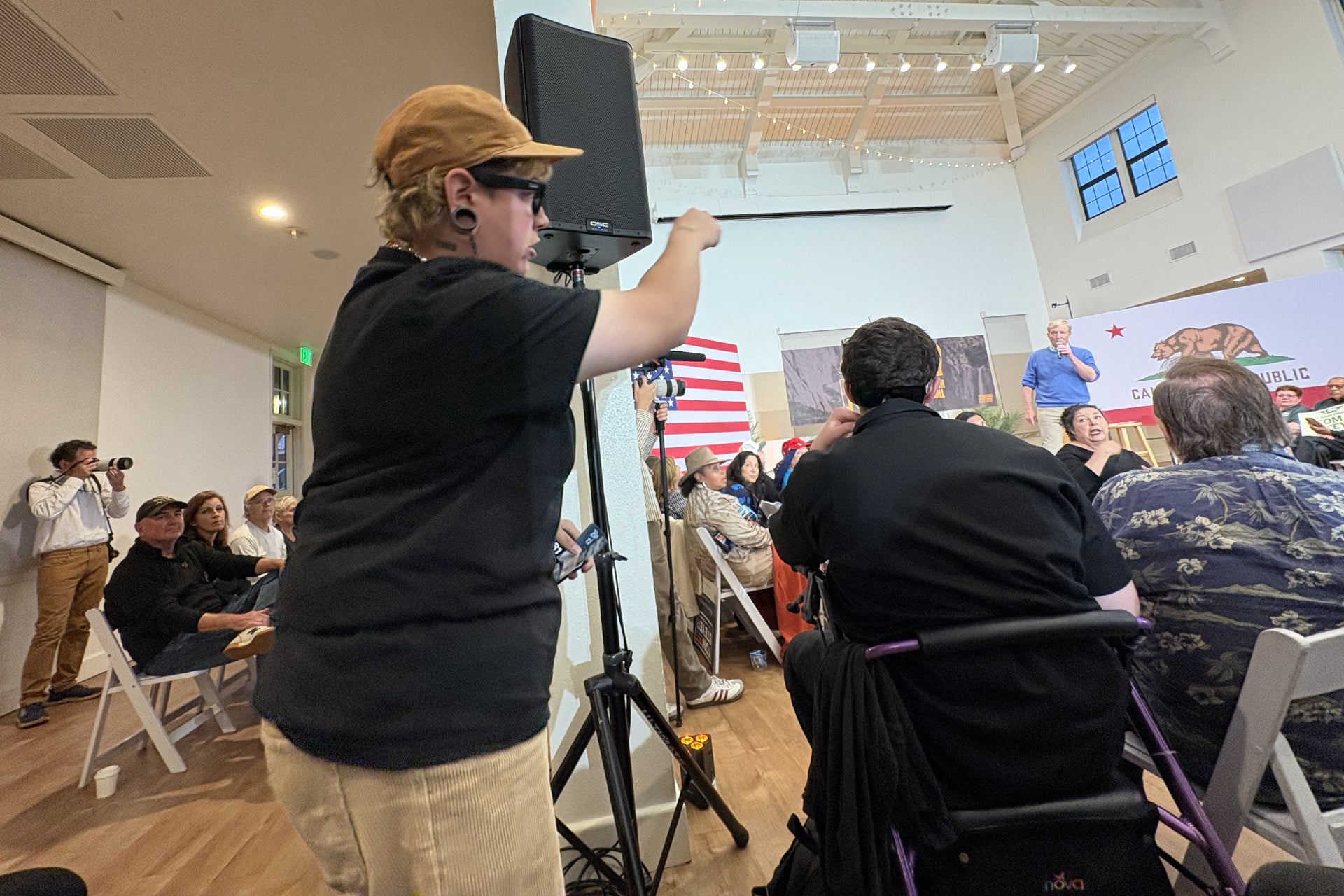 One of three protesters from the anti-ICE Otay Mesa Detention Collective who stood up during Tom Steyer's town hall and voiced opposition to the money he made investing in the private prison company CoreCivic.