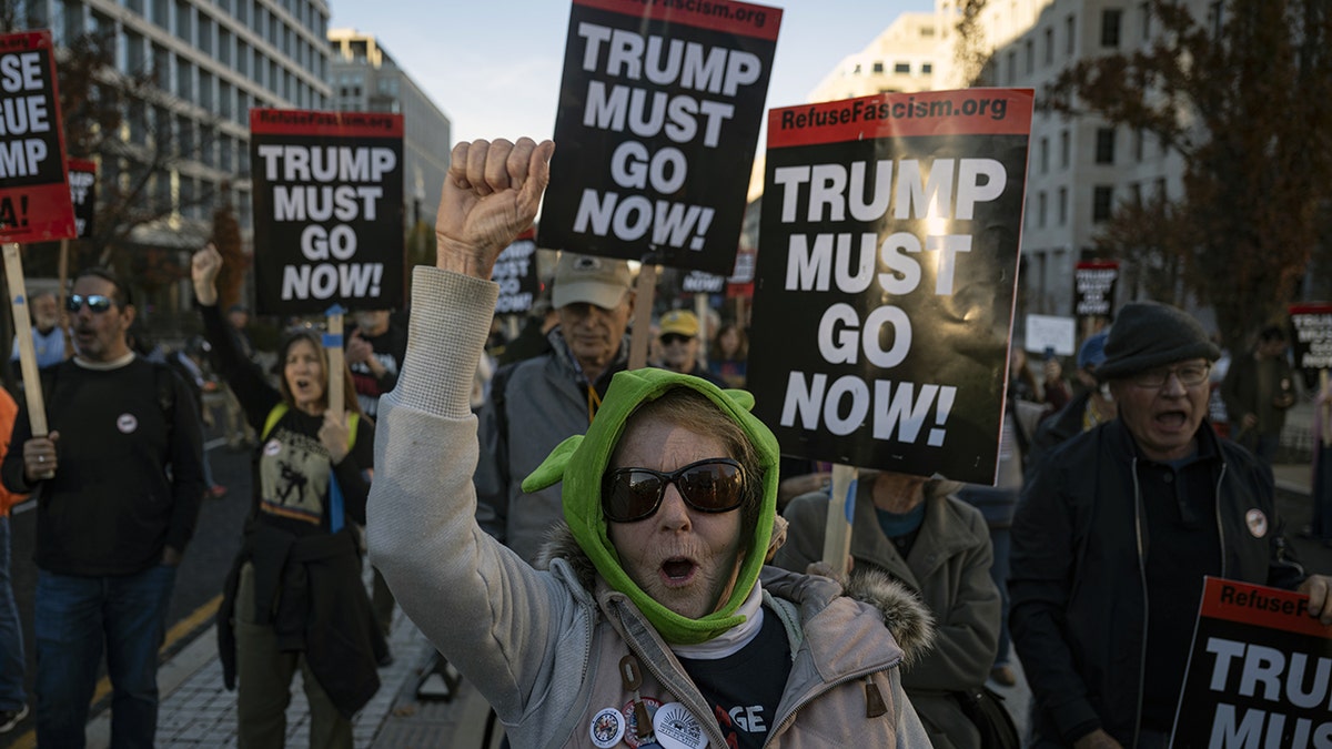 Female protester raising fist at anti-Trump protest in Washington, D.C.