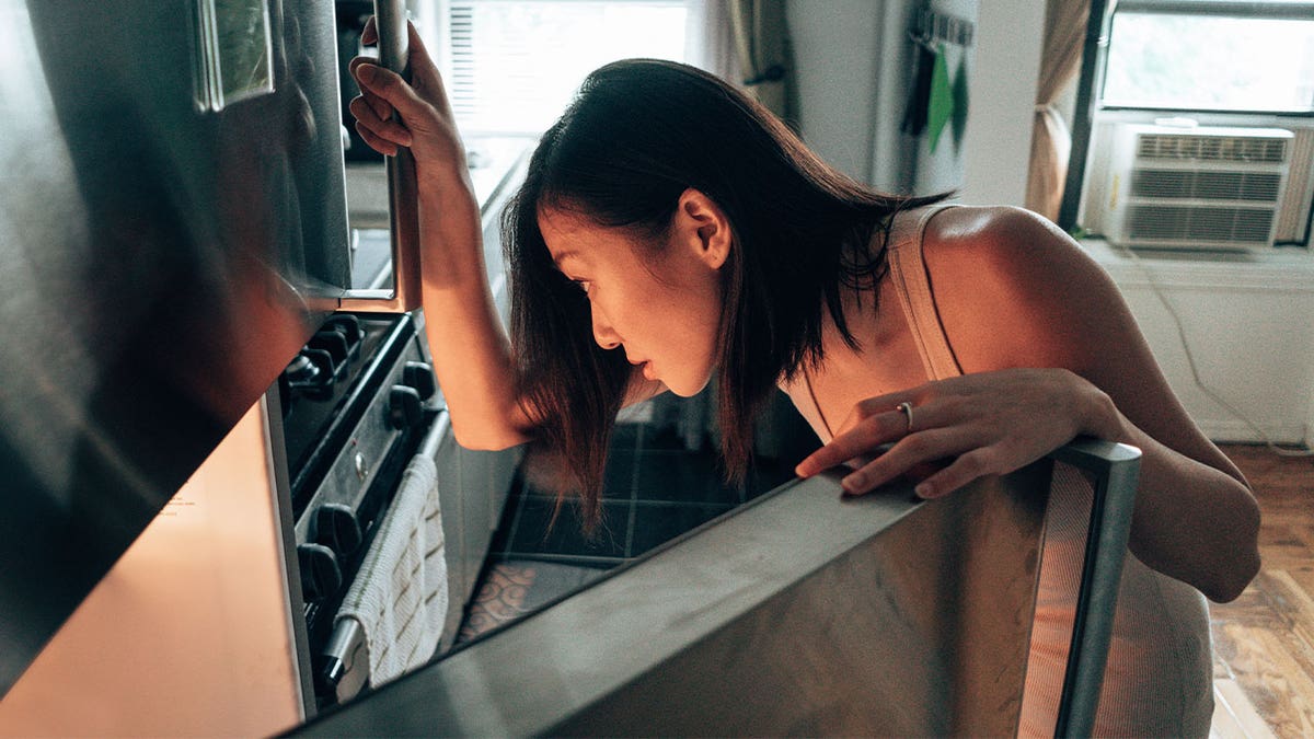 Woman looking in fridge