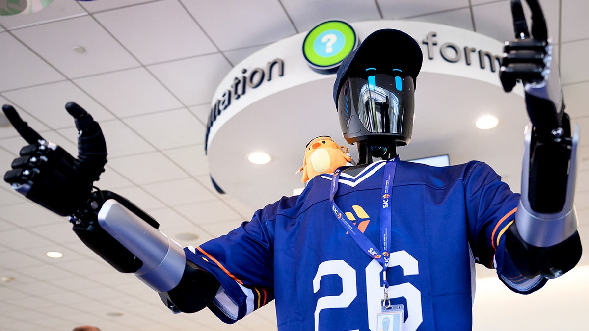 A humanoid robot wears a jersey with the number 26. 