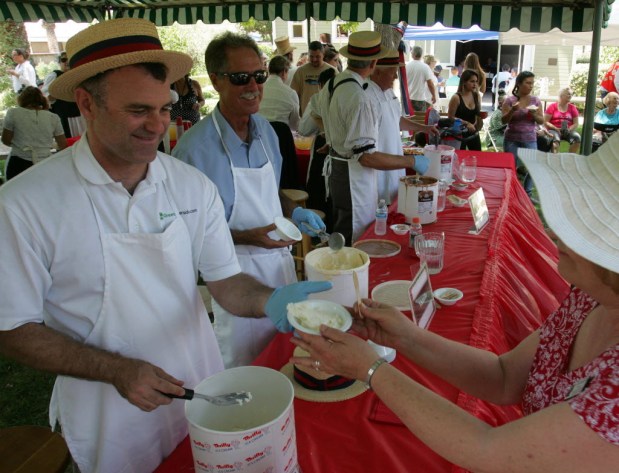 Riverside Mayor Rusty Bailey, left, and Councilman Jim Perry scoop up portions for visitors at the 23rd annual Ice Cream Social at Riverside's Heritage House in 2016. /File photo by David Bauman, The Press-Enterprise/SCNG