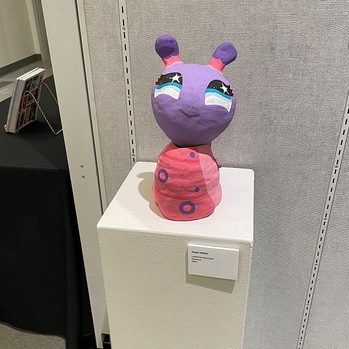 pink colored art piece made of ceramics depicting a cartoon character
