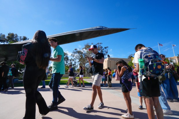 Visitors waited in line at the San Diego Air & Space Museum in Balboa Park to watch the live stream of NASA's feed as the four-person crew of Artemis II splashed down off the coast of California on April 10, 2026.  (Nelvin C. Cepeda / The San Diego Union-Tribune)