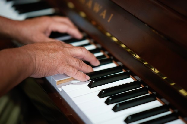 John Conroy, 68 entertains the guest at Serving Seniors with piano music in the dining room on Tuesday, March 17, 2026 in San Diego, CA. It was not a formal performance. It is simply what John Conroy does effortlessly and with passion every day. Being at Serving Seniors, he says, is like a second home. "It makes you feel like you have a family." Just over three years ago, Conroy was sleeping outside in Balboa Park with nowhere to go and no idea what came next. Today, he has a place to live, and he has a purposeto help other unhoused seniors. He shares his musical gift with hospitals, churches, and the San Diego seniors who have become his family. (Nelvin C. Cepeda / The San Diego Union-Tribune)