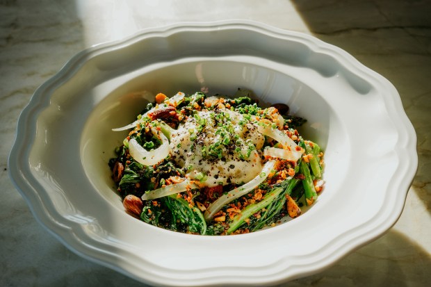 Grilled Yu Choy, an extra smokey vegetable dish with soubise sauce at Trust Restaurant Group's À L'ouest, a modern French brasserie in North Park. (Trust Restaurant Group)